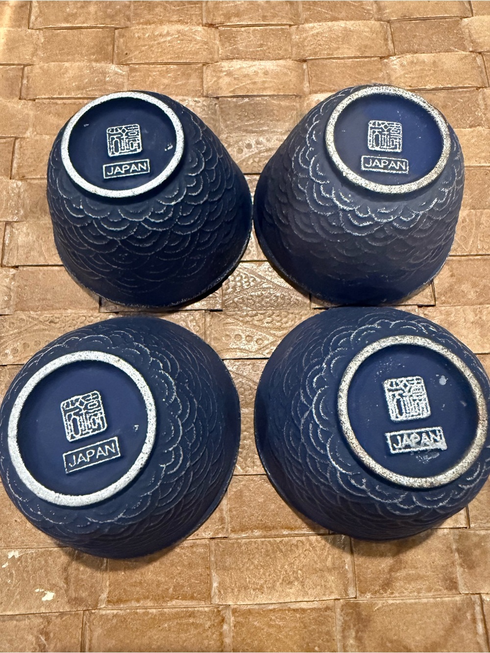 Set of four Japanese cast iron teacups with enamel interior